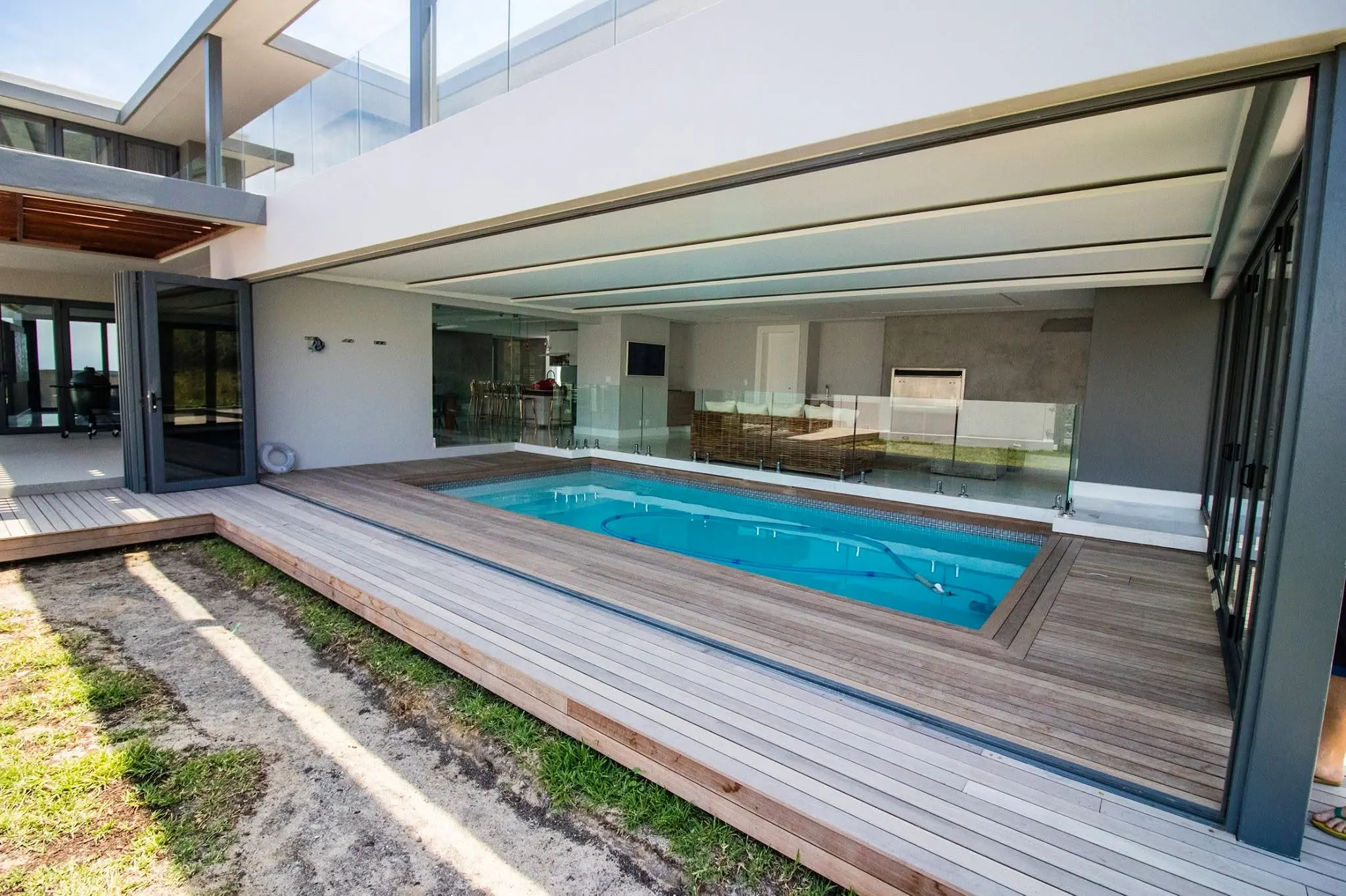 Wide completed pool elevation with aluminium stack-away doors at Baronetcy Estate