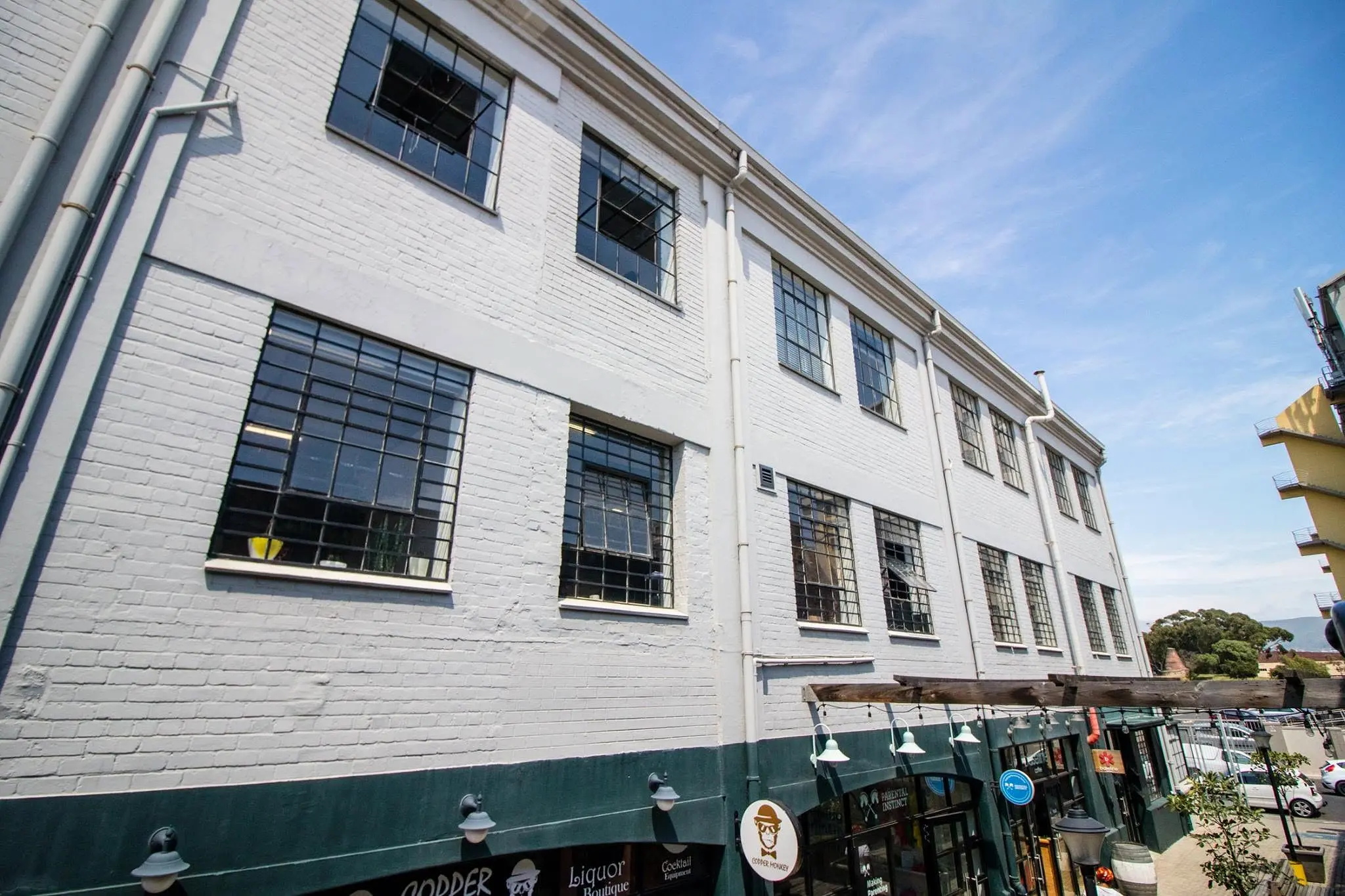 Detailed white-brick façade with restored steel windows at Mason's Press