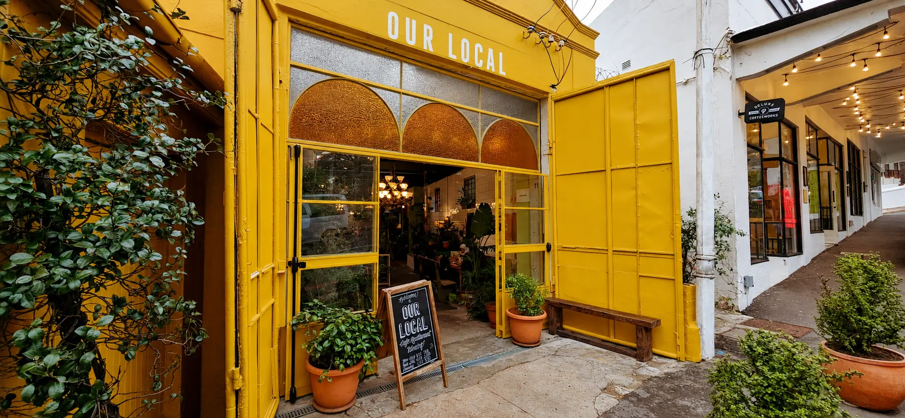 Completed yellow custom steel restaurant shopfront at Our Local in Cape Town