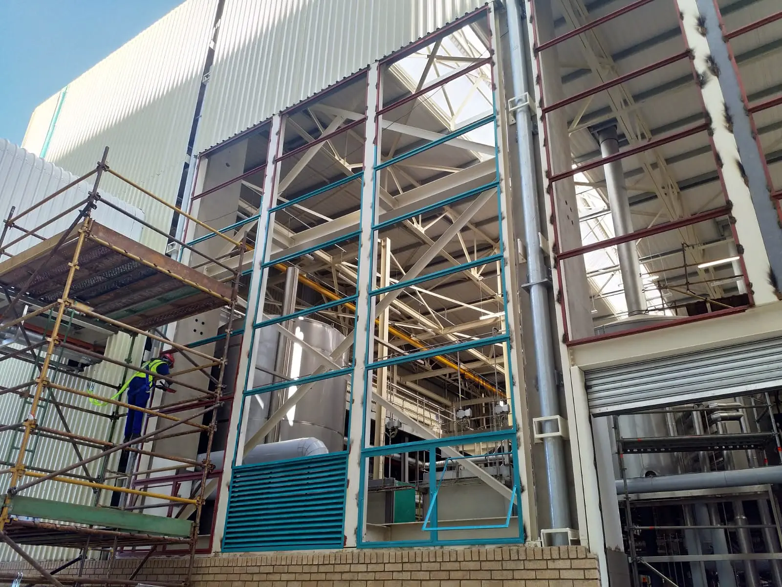 Tall industrial steel-window bays during the Rosslyn rectification programme